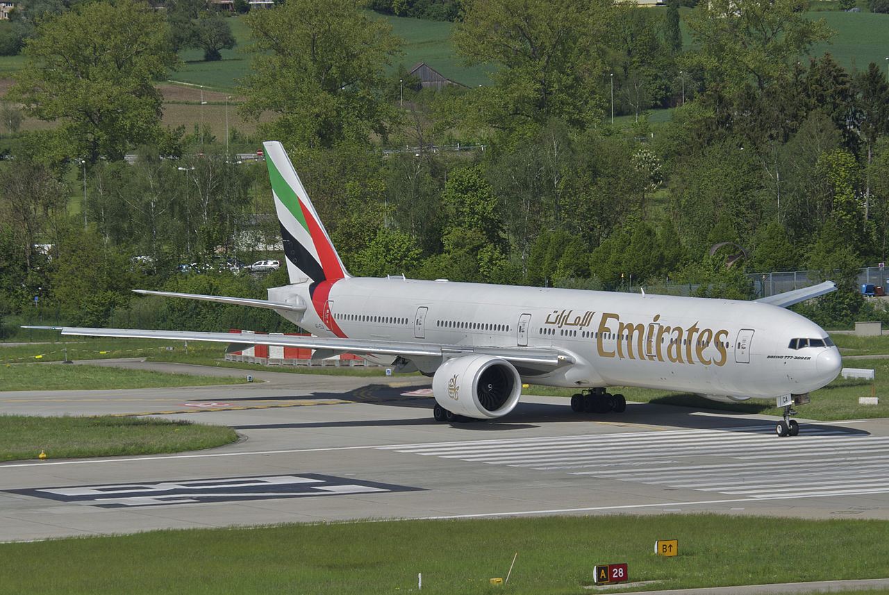 An Emirates Boeing 777 lines up on the runway.