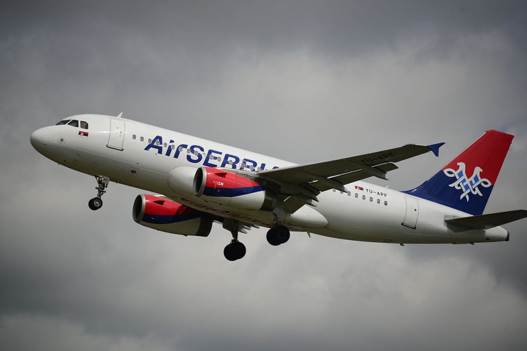 An Air erbia A319 takes off in an overcast sky.