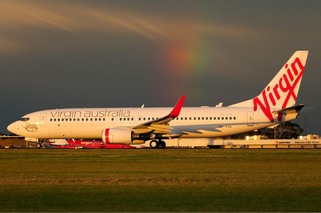 A Virgin Australia Boeing 737 taxis under an overcast sky.