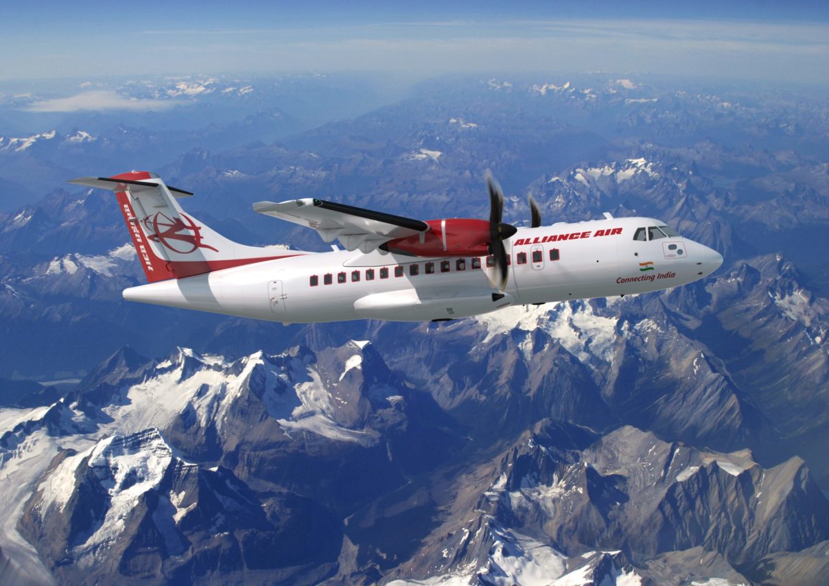 an Alliance Air ATR turboprop aircraft flying above mountains.