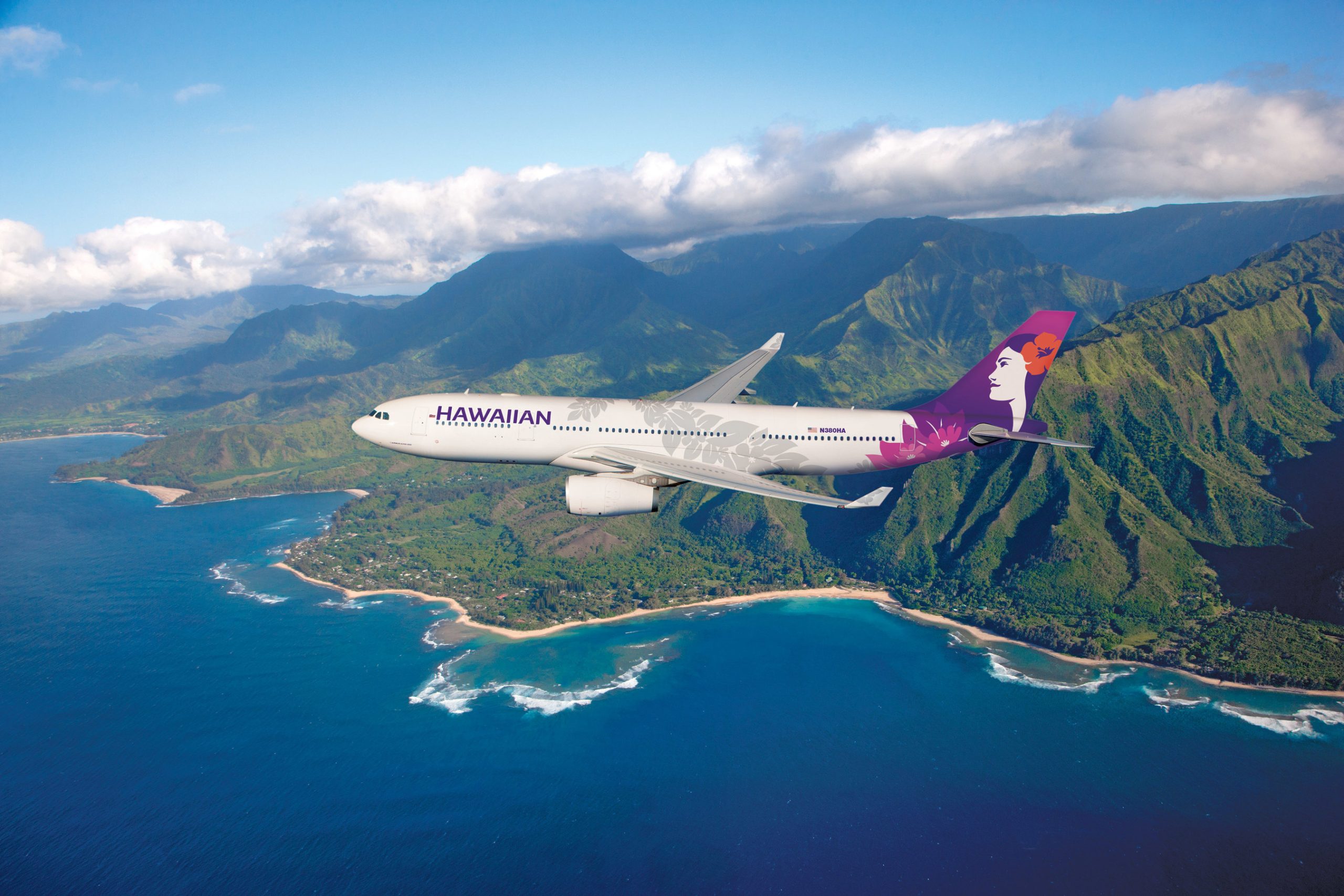 A Hawaiian Airlines jet over mountains.