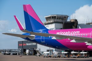 A Wizz Air aircraft taxiing past Cardiff Airport control tower