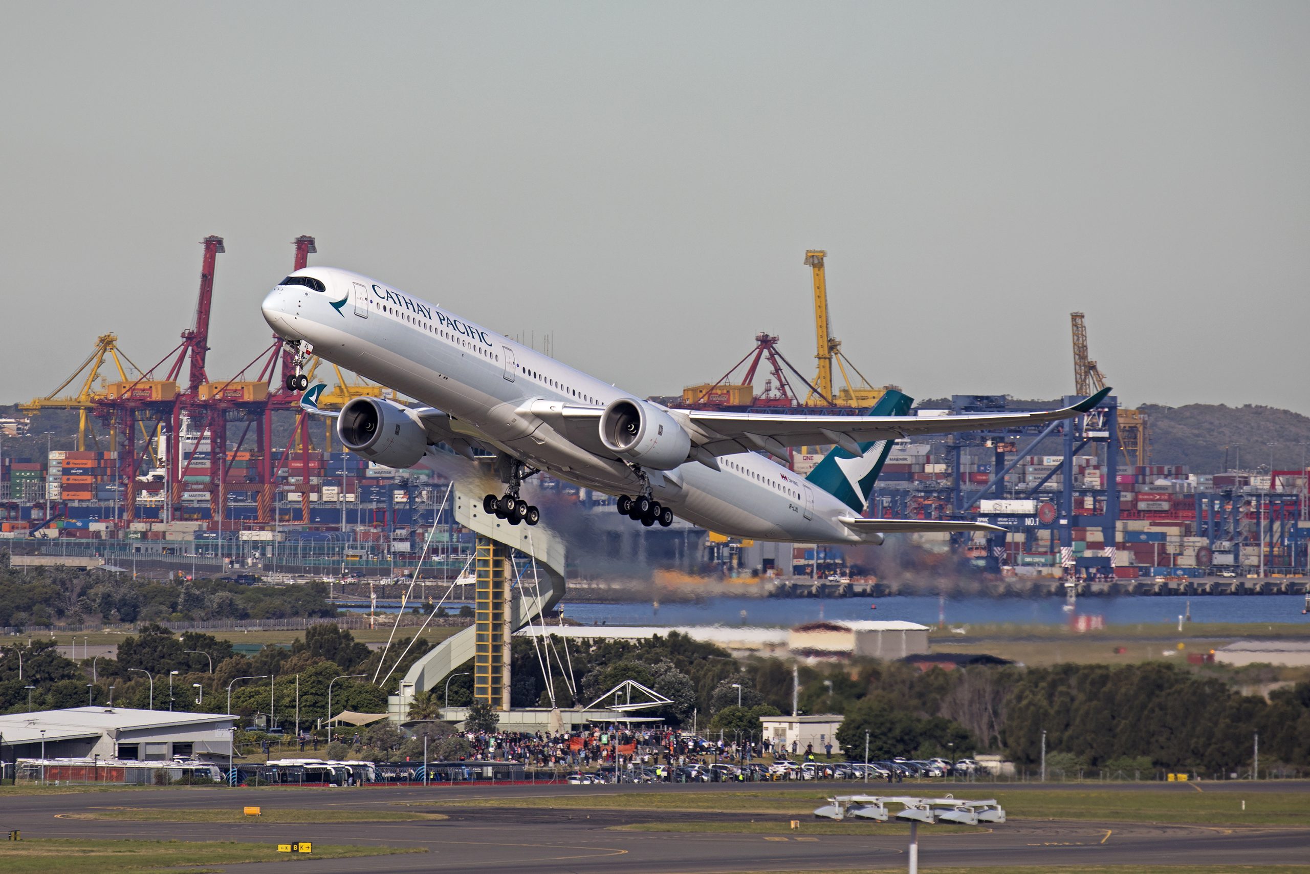 A Cathay Pacific A350 climbs after takeoff.