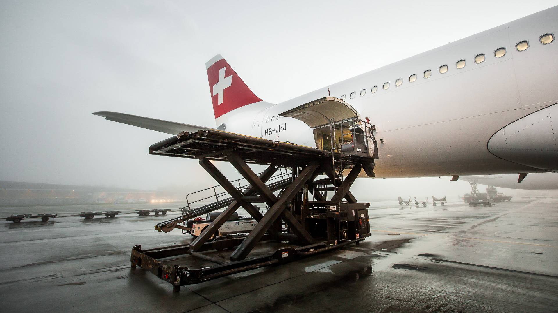 Cargo is loaded aboard Swiss Air Lines aircraft.