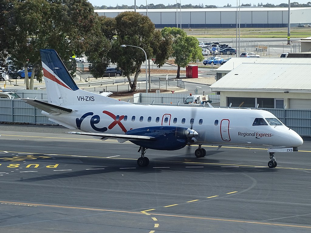 A Rex Airlines Saab 340 parked at the terminal.