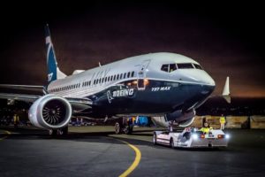The prototype Boeing 737 mAX being towed on the tarmac.