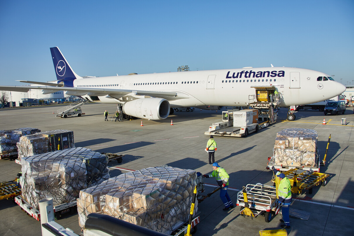 Lufthansa ground staff loading air cargo.