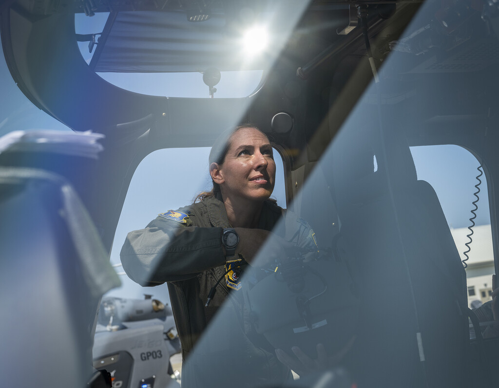 Lt. Col. Mary Clark, USAF 96th Operations Group, stows her helmet inside the MH-139 Grey Wolf helicopter. 