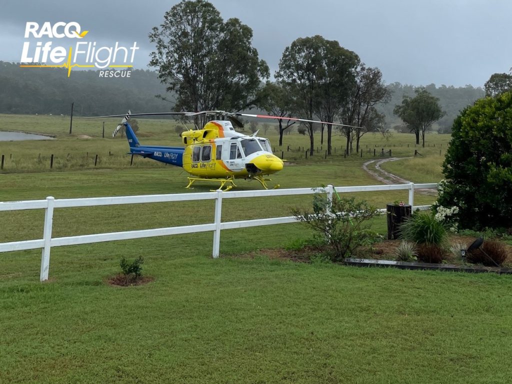 RACQ LifeFlight Helicopter in field.