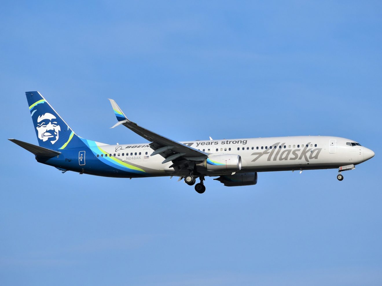 An Alaska Airlines flight approaching EWR Airport with landing gear down.