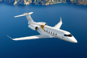 Bombardier Challenger 3500 aircraft flying over coastline.