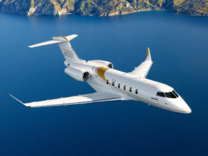Bombardier Challenger 3500 aircraft flying over coastline.