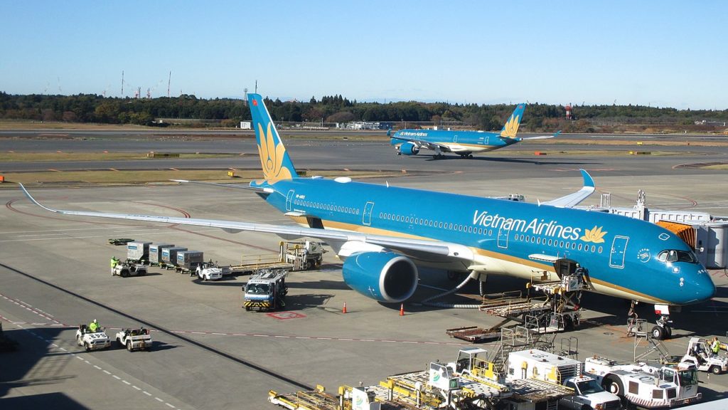 An Vietnam Airlines Airbus aircraft waits at Narita terminal as another one leaves.