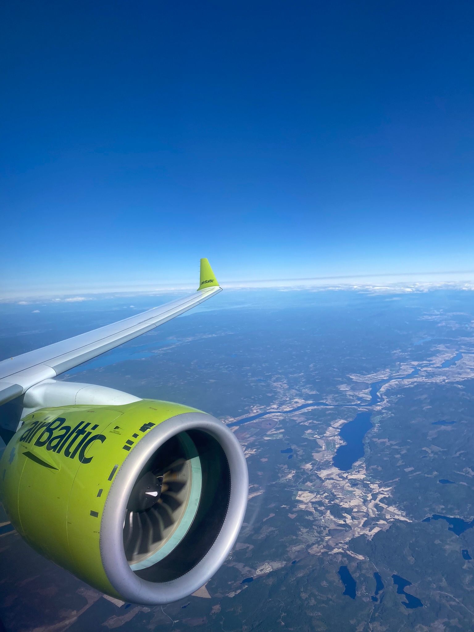 A view from the cabin window of an airbaltic Airbus flying enroute to Riga.