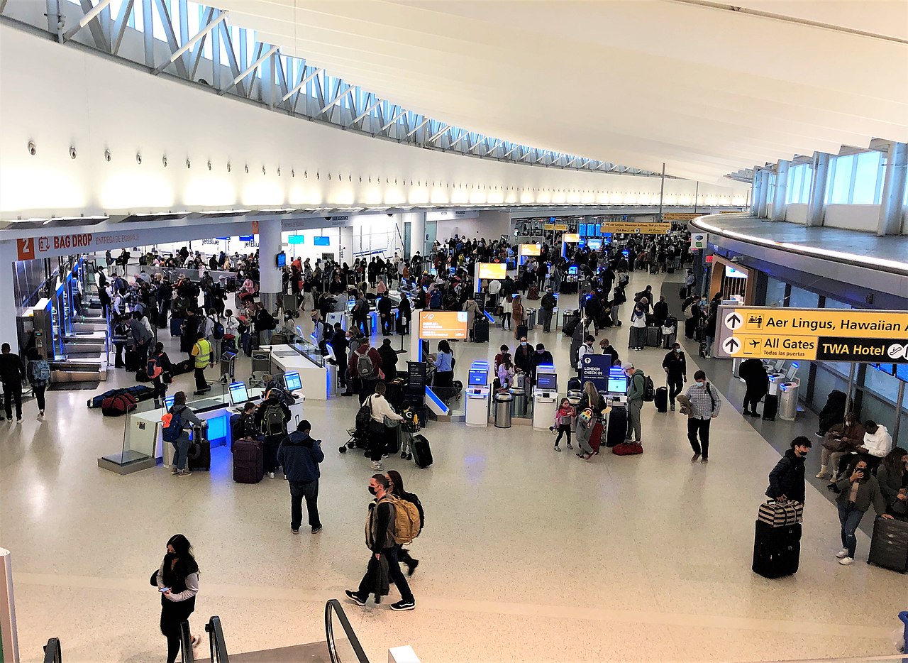 Busy passenger terminal at JFK airport.