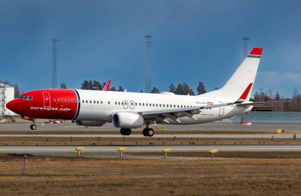 A Norwegian airline Boeing lines up for takeoff.
