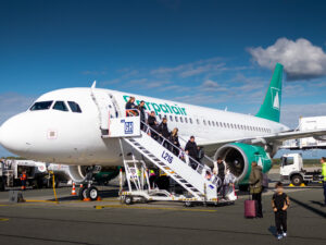 Passengers exit a Carpatair flight onto the yarmac.