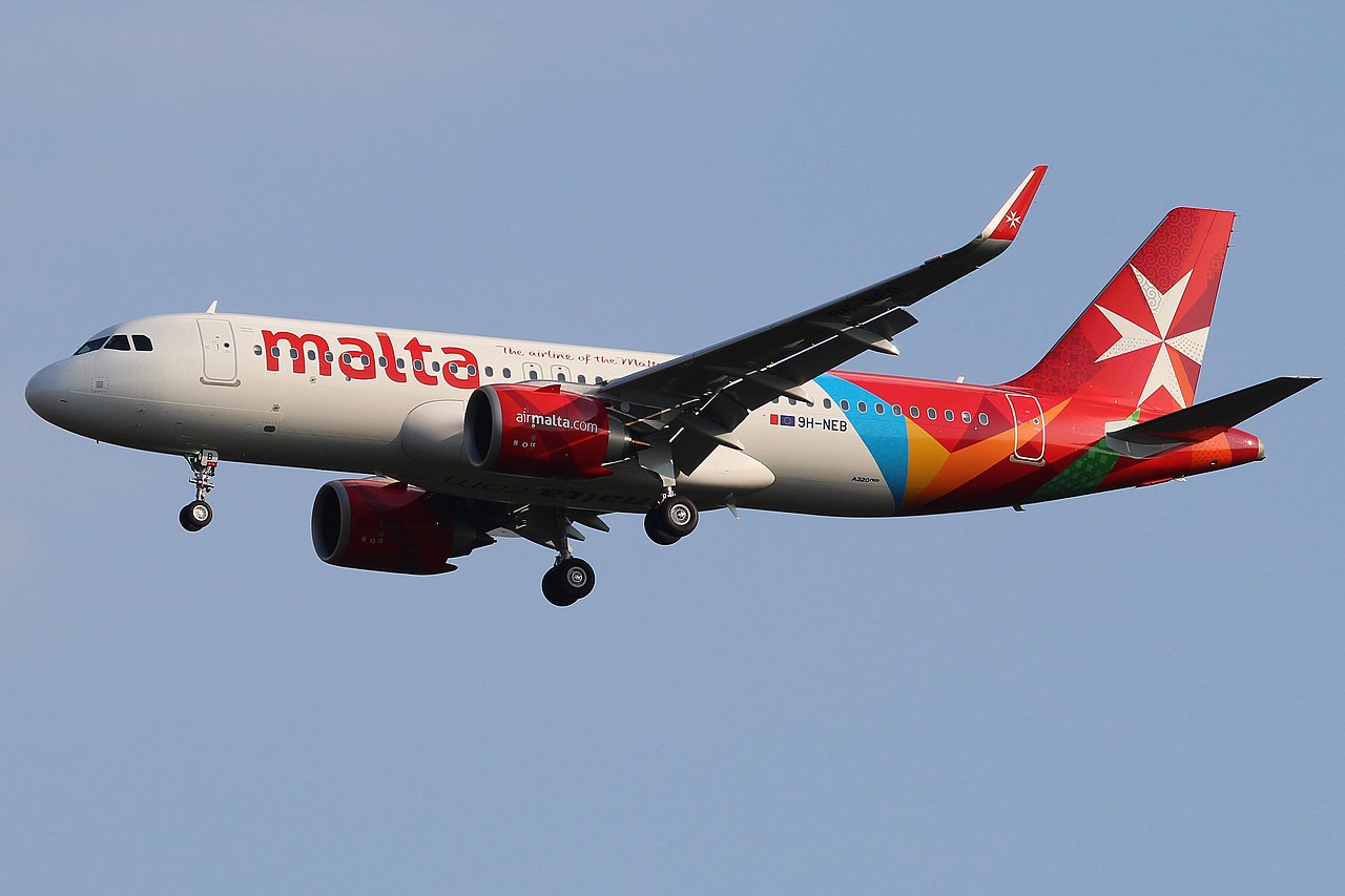 An Air malta Airbus approaching to land with wheels down.
