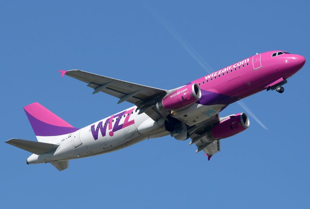 A Wizz Air Airbus passing overhead.