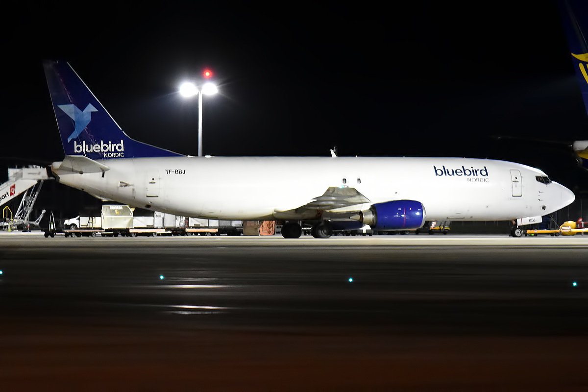 A Bluebird Nordic Boeing 737 freighter on the tarmac at night.