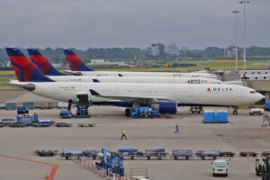 A line of Delta Airlines aircraft parked at the terminal.