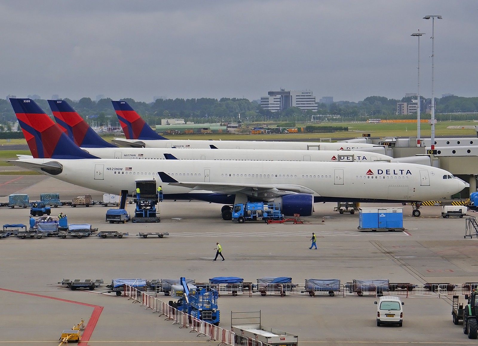 A line of Delta Airlines aircraft parked at the terminal.
