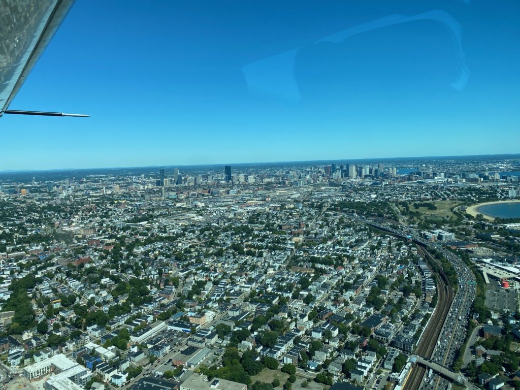 View of Boston city from Tailwind Air seaplane on a clear blue day.