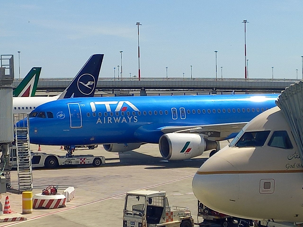 And ITA airways aircraft parked at Rome airport with other airliners surrounding it.