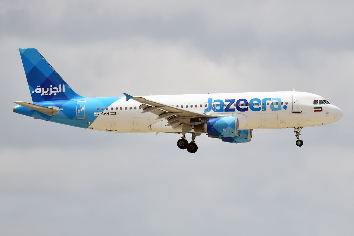 A Jazeera Airways Airbus approaching with wheels down.