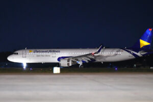 A Vietravel Airlines aircraft parked at night.