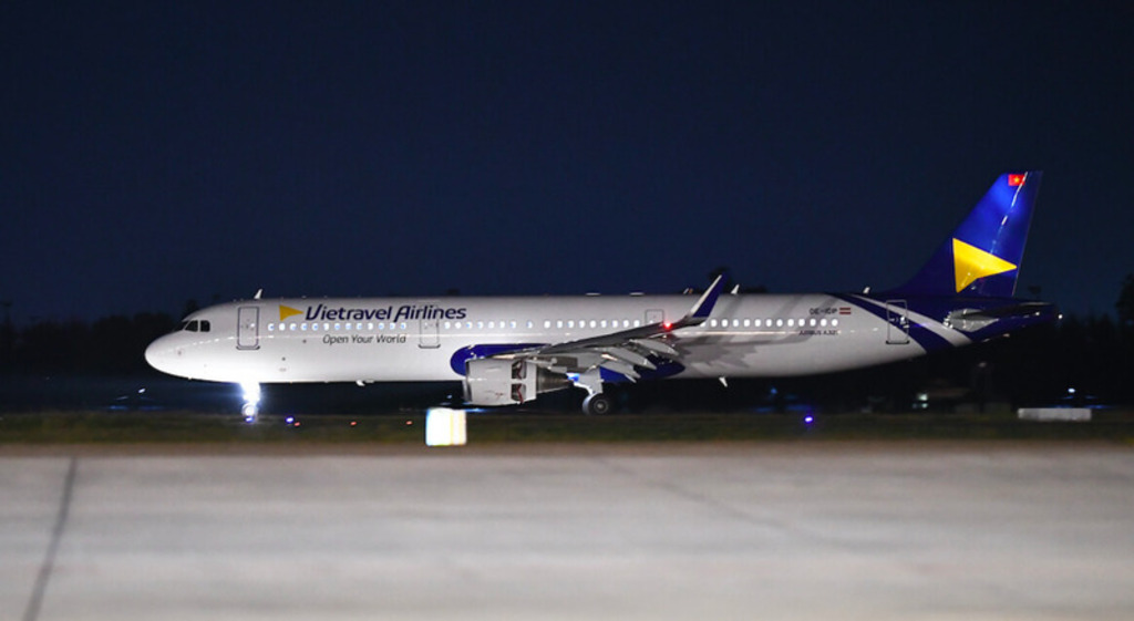 A Vietravel Airlines aircraft parked at night.