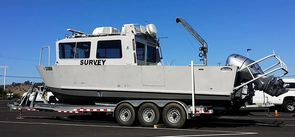 NTSB survey vessel on a trailer, ready to be deployed on the search for the missing aircraft in Mutiny Bay.