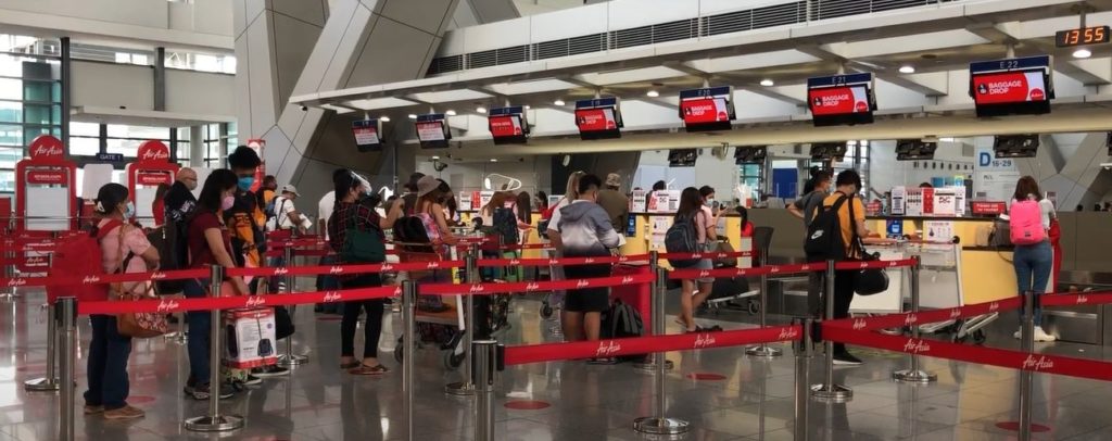 AirAsia Philippines airport terminal with passengers queuing during the Ber month holiday season.