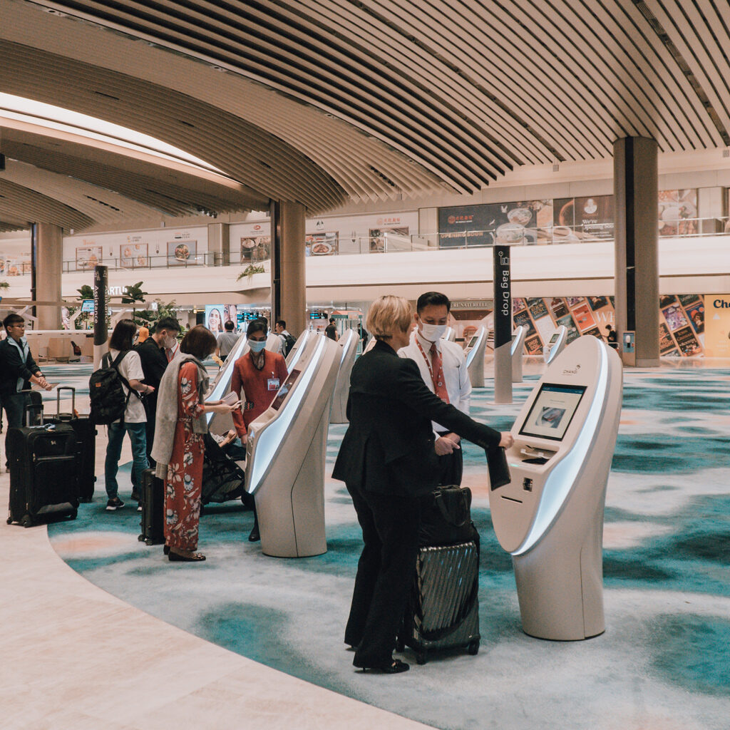 Passengers check-in at new booths in Singapore Changi Airport T2 facility.