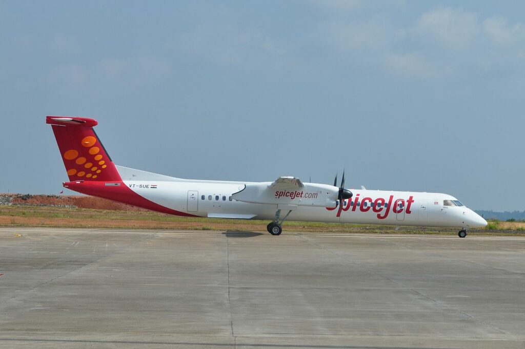 A SpiceJet Q400 aircraft lined up for takeoff.