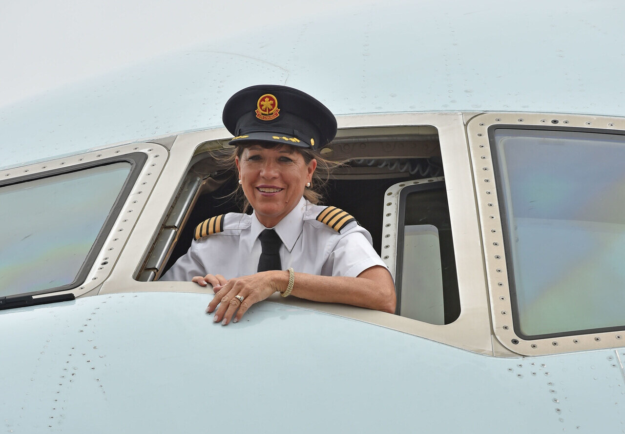 Captain Judy Cameron at the open window of an Air Canada jet.