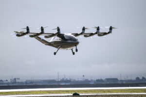 The Archer Aviation eVTOL prototype aircraft hovering above the ground.