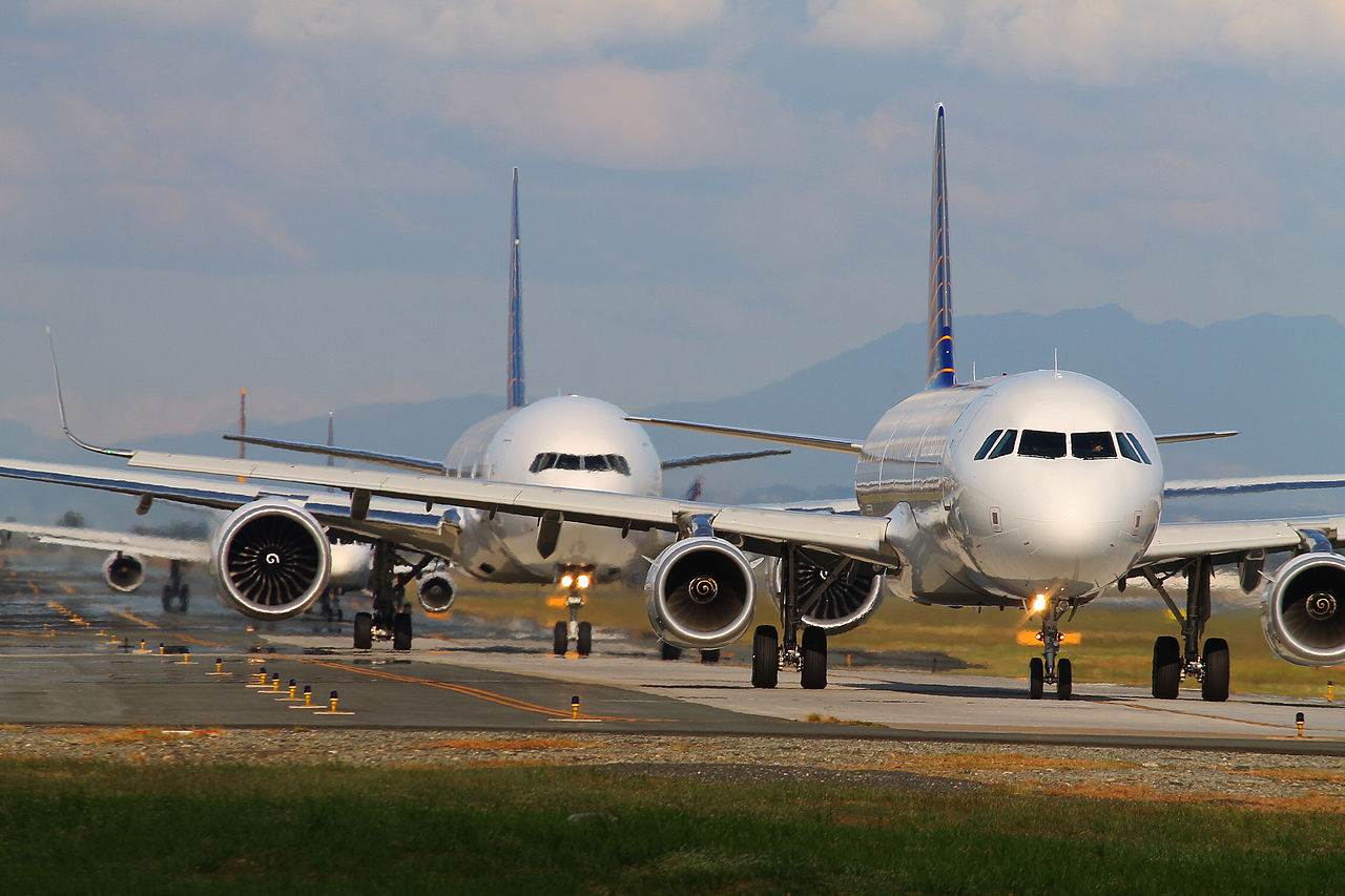 Aircraft lined up on a busy airport taxiway.