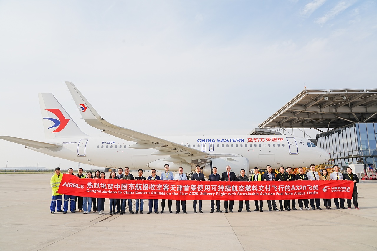 A China Eastern Airbus A320 at Tianjin surrounded by people celebrating its departure.