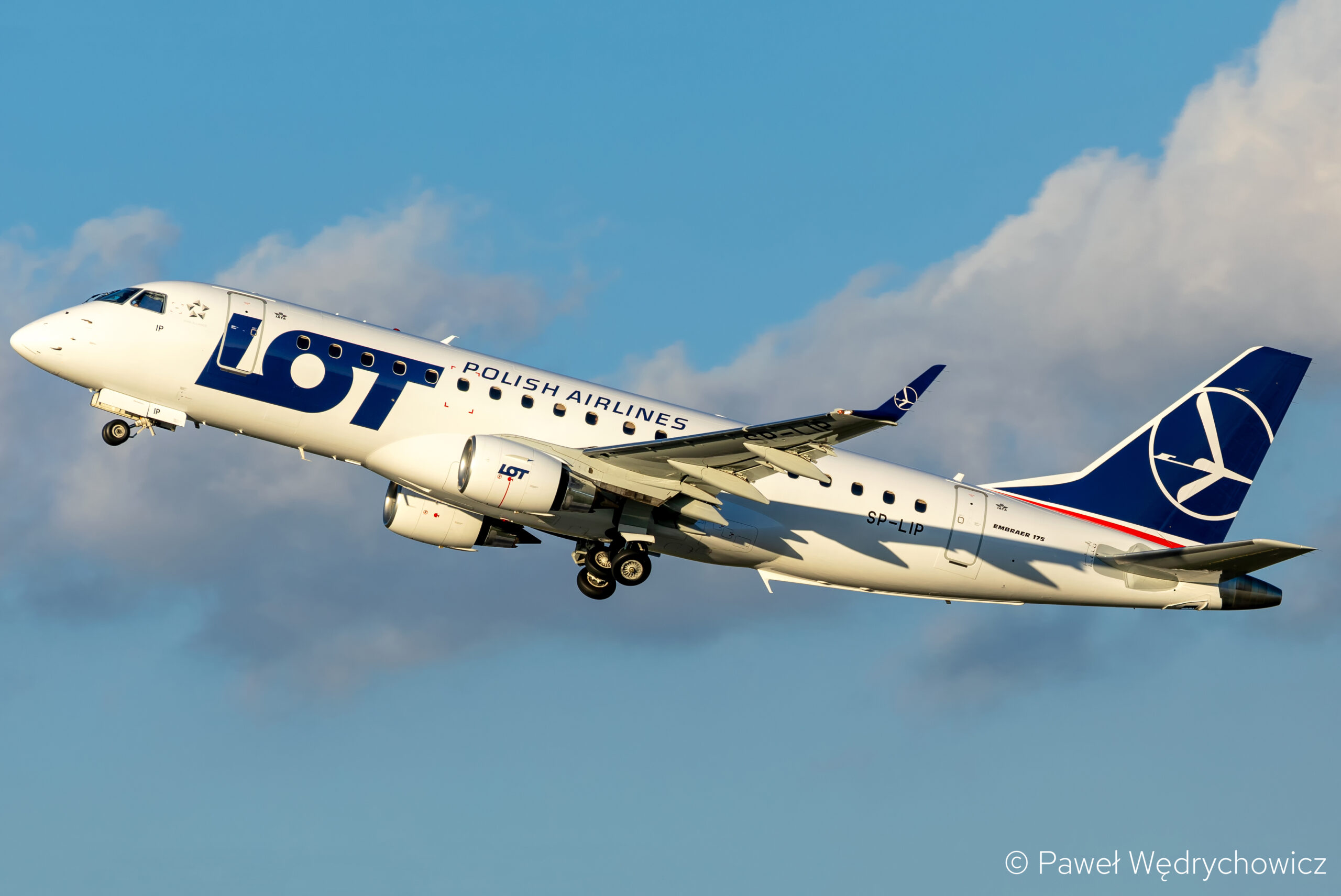 A LOT Polish Airlines E-Jet climbing after takeoff.
