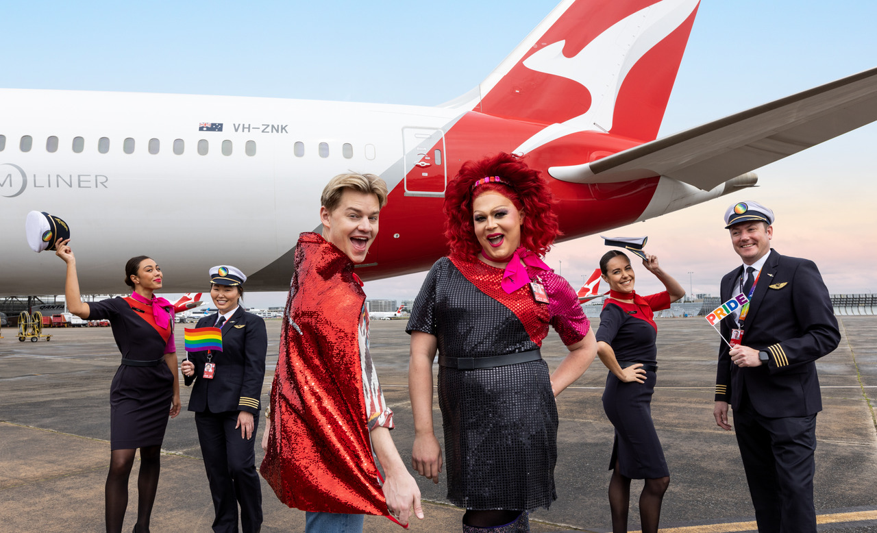 Qantas crew members pose gaily for the WorldPride special flight service.