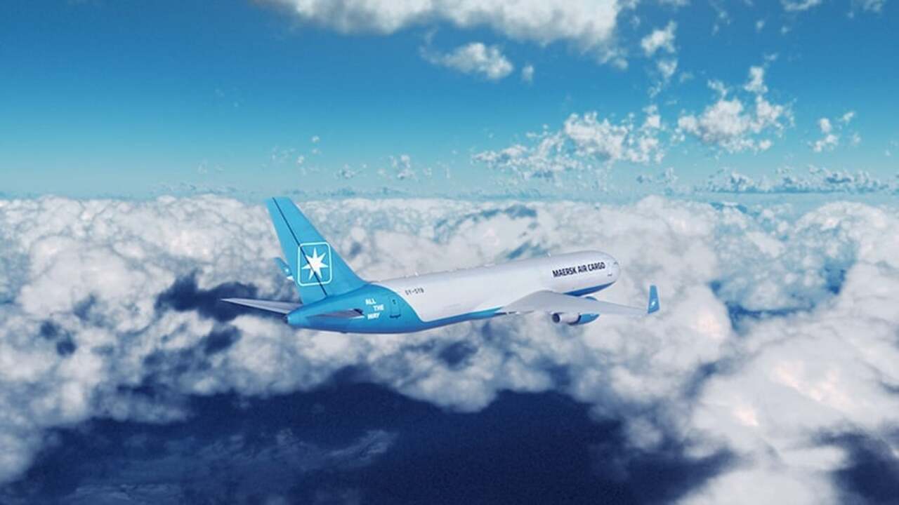 A Maersk Air Cargo freighter aircraft flying above cloud.