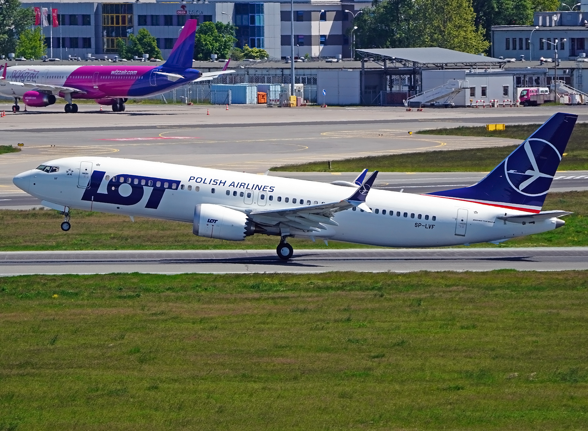 A LOT Polish Airlines 737 MAX aircraft lifts off the runway.