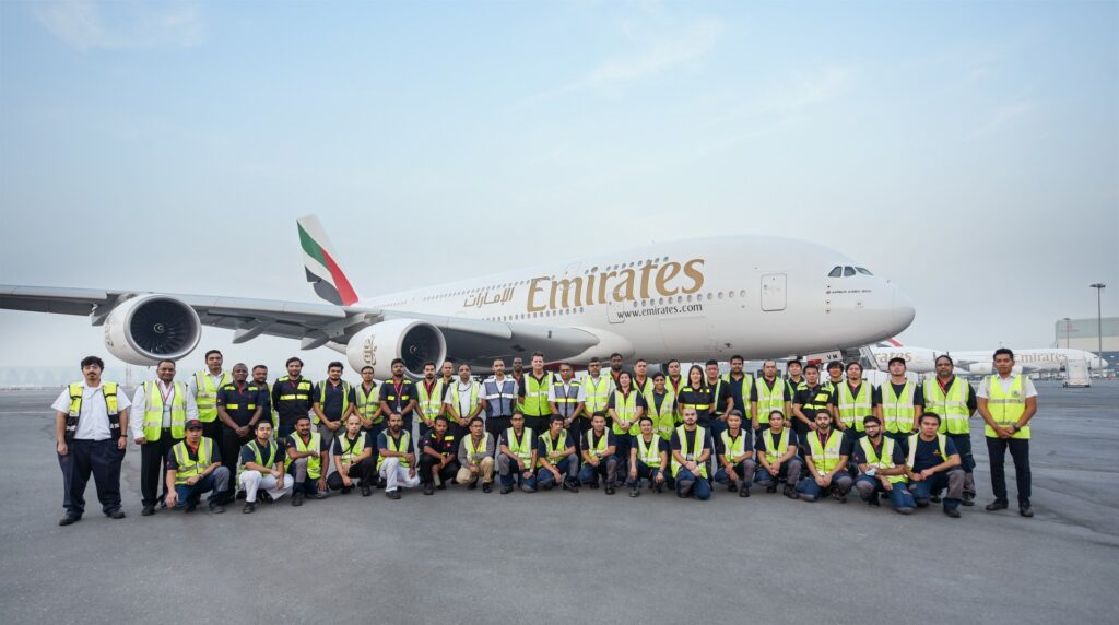 The Emirates retrofit team stand in front of an A380.