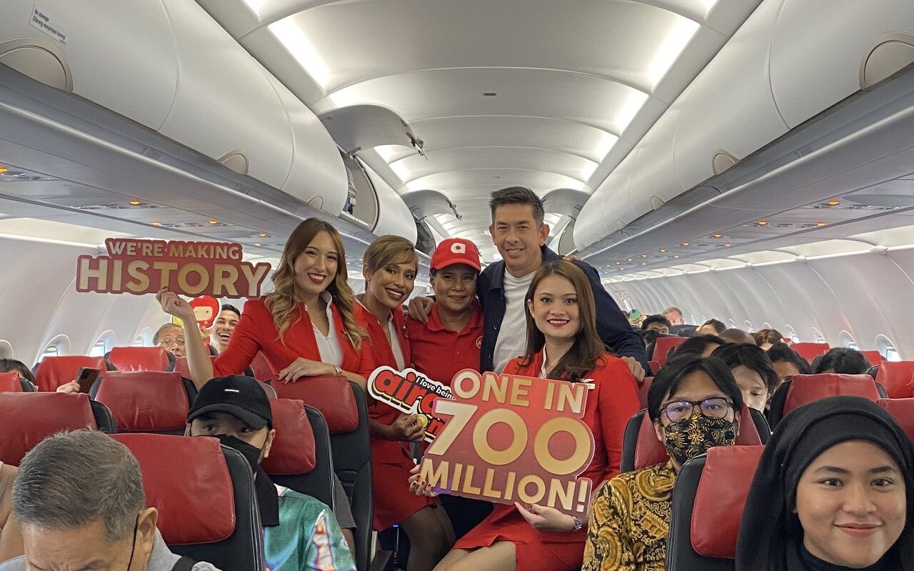 Passengers and crew celebrate aboard an AirAsia flight