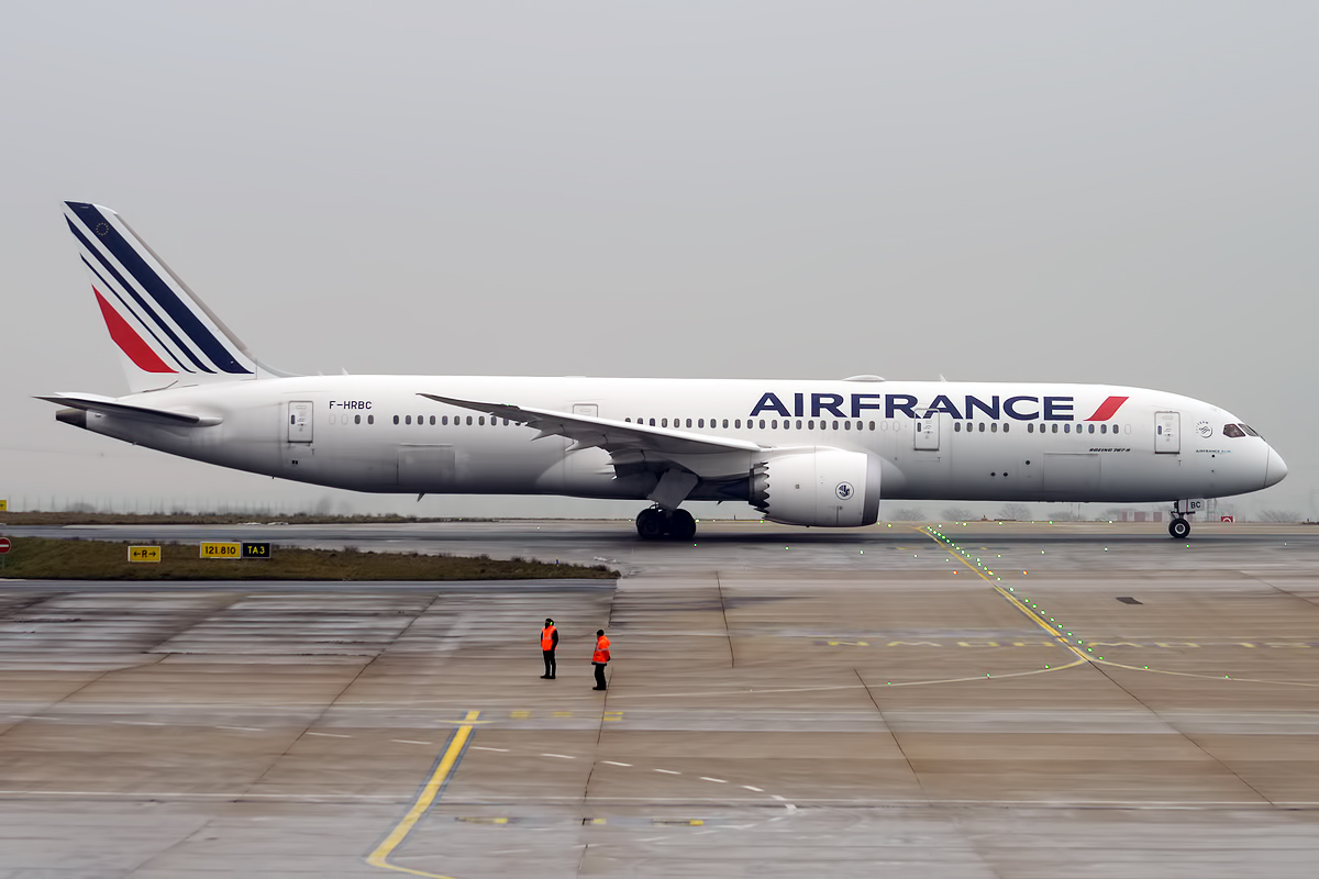 An Air France Boeing 878 Dreamliner parked on the tarmac.