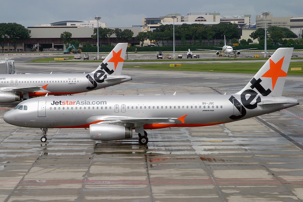 Two Jetstar Asia aircraft parked at the terminal.
