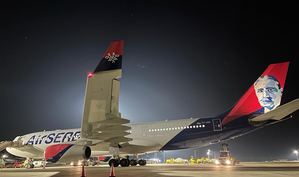 The new Air Serbia Airbus named Mihajlo Pupin lands at Belgrade at night.