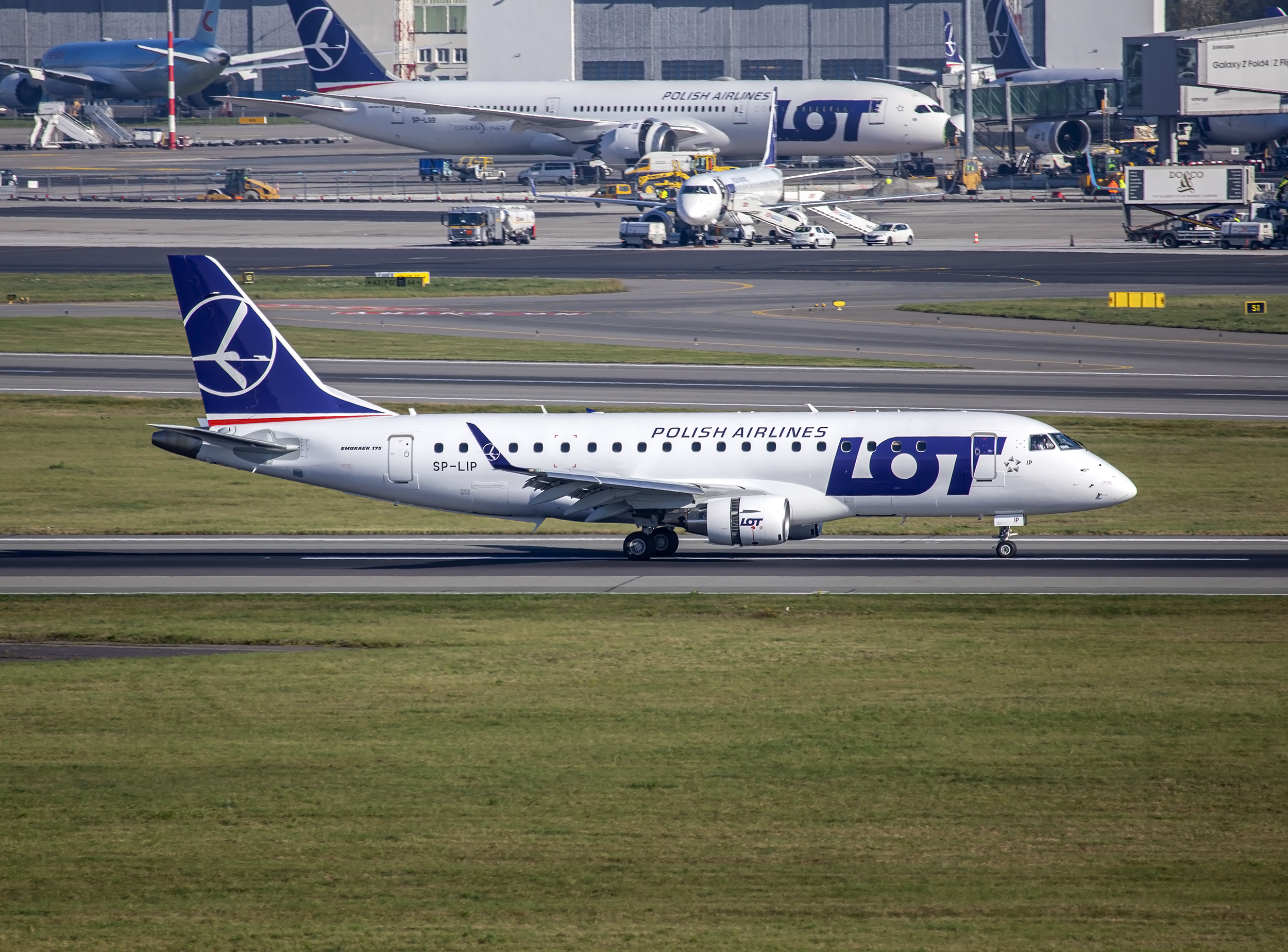 A new LOT Polish Airlines Embraer E175 touches down in Warsaw.