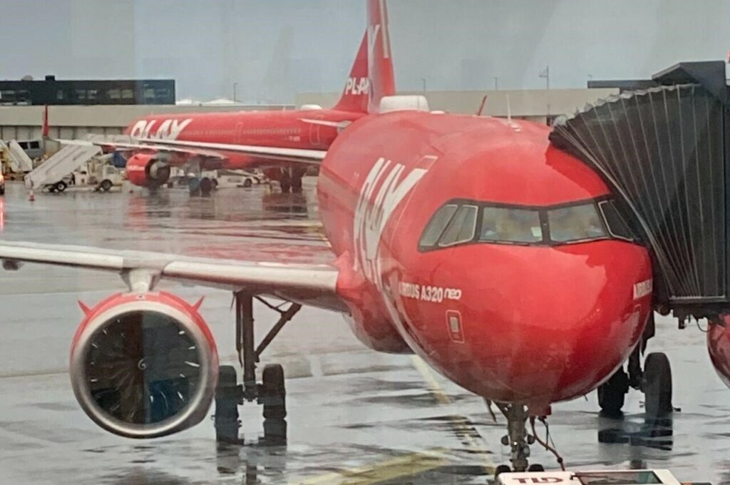 A PLAY Airbus A320 parked at the Keflavik terminal.